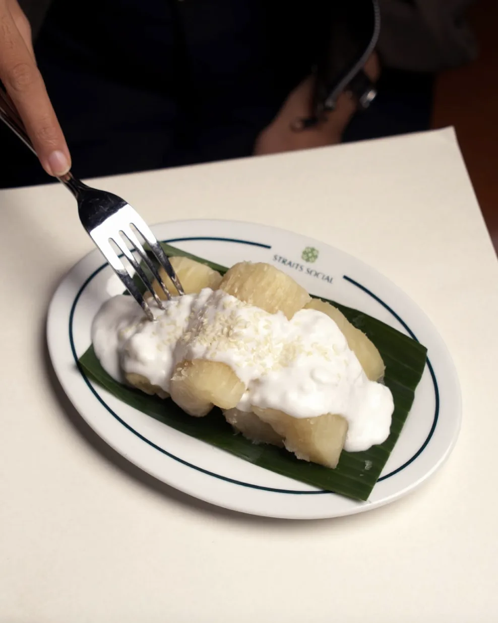 Fermented cassava with coconut sauce on a banana leaf
