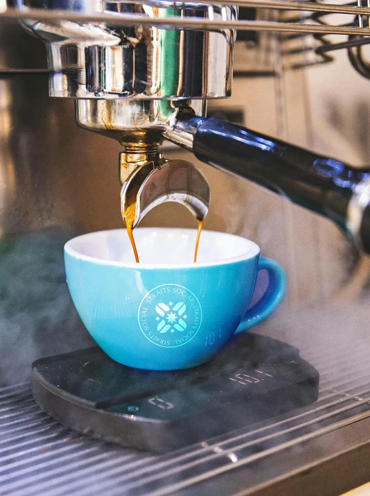 Espresso poured into a blue cup at the coffee bar